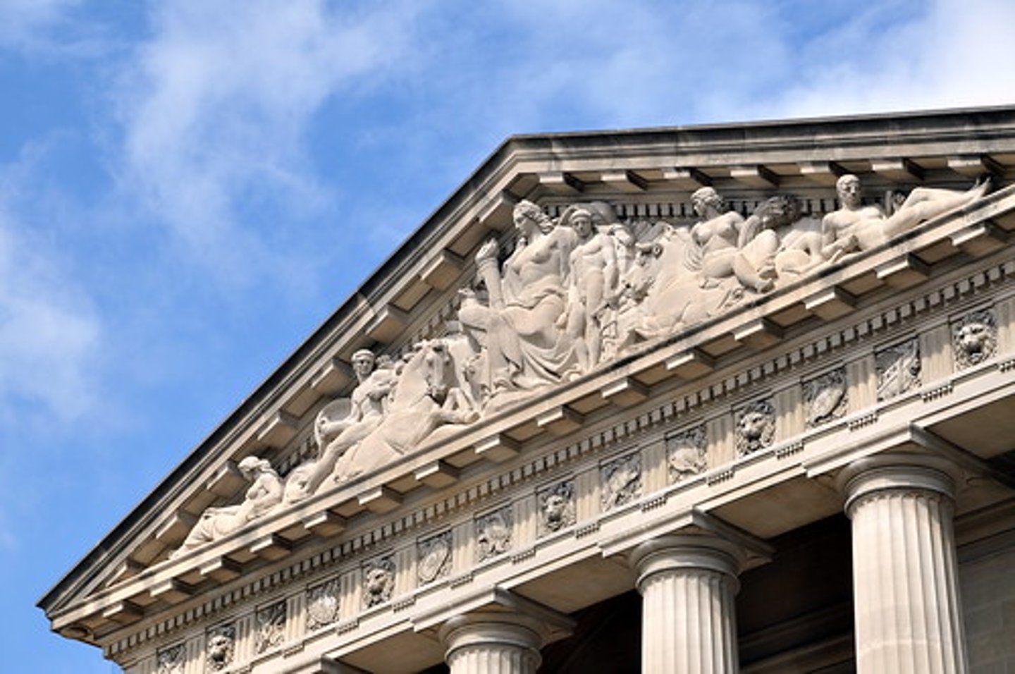 <p>the triangular top of a temple that contains sculpture</p>