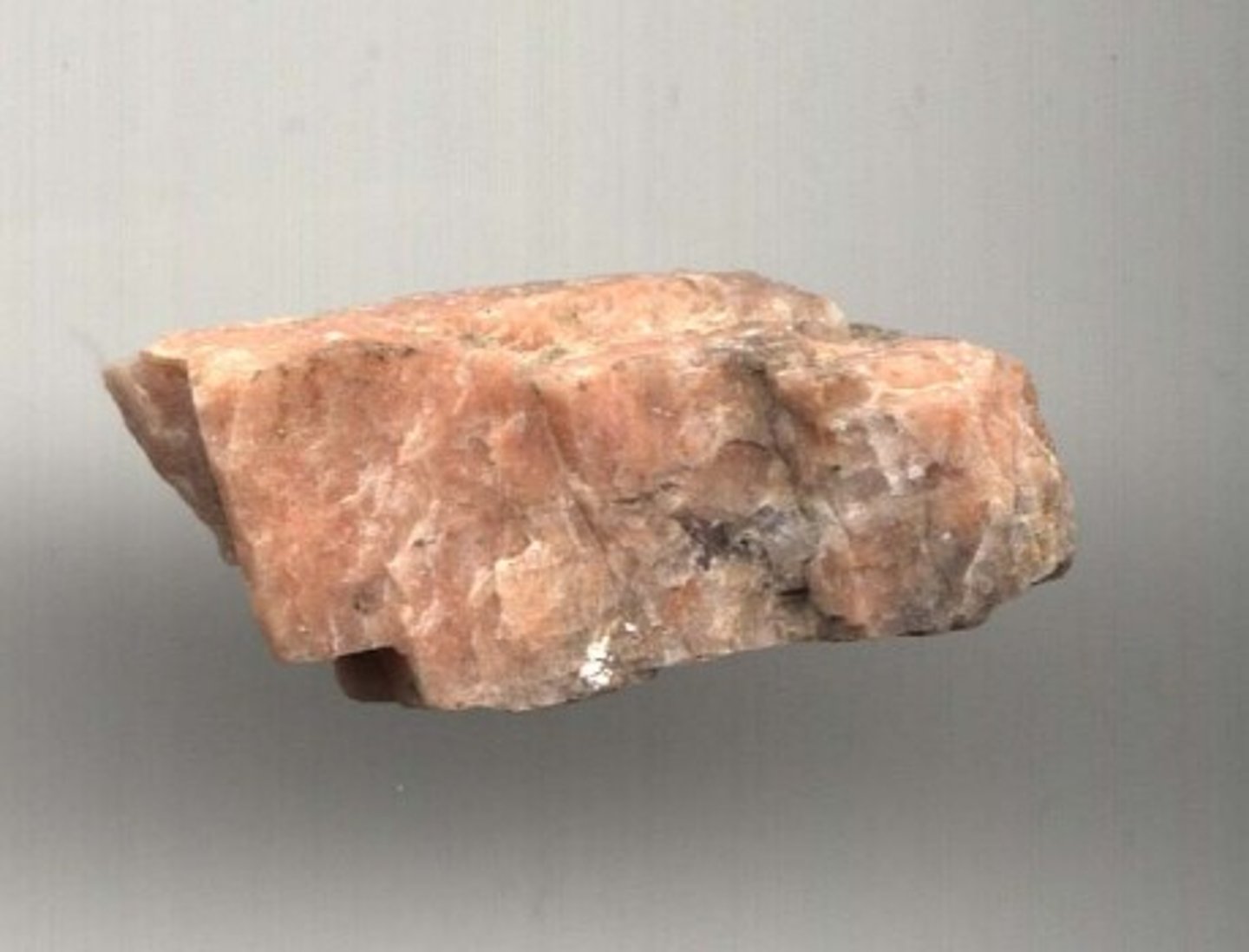 <p><strong>hardness:</strong> 6<br><strong>cleavage:</strong> 2 directions, usually at 90 degrees<br><strong>luster:</strong> vitreous to pearly<br><strong>color:</strong> pink, can be whitish<br><strong>other notes:</strong> block-like, looks like muscle tissue</p>