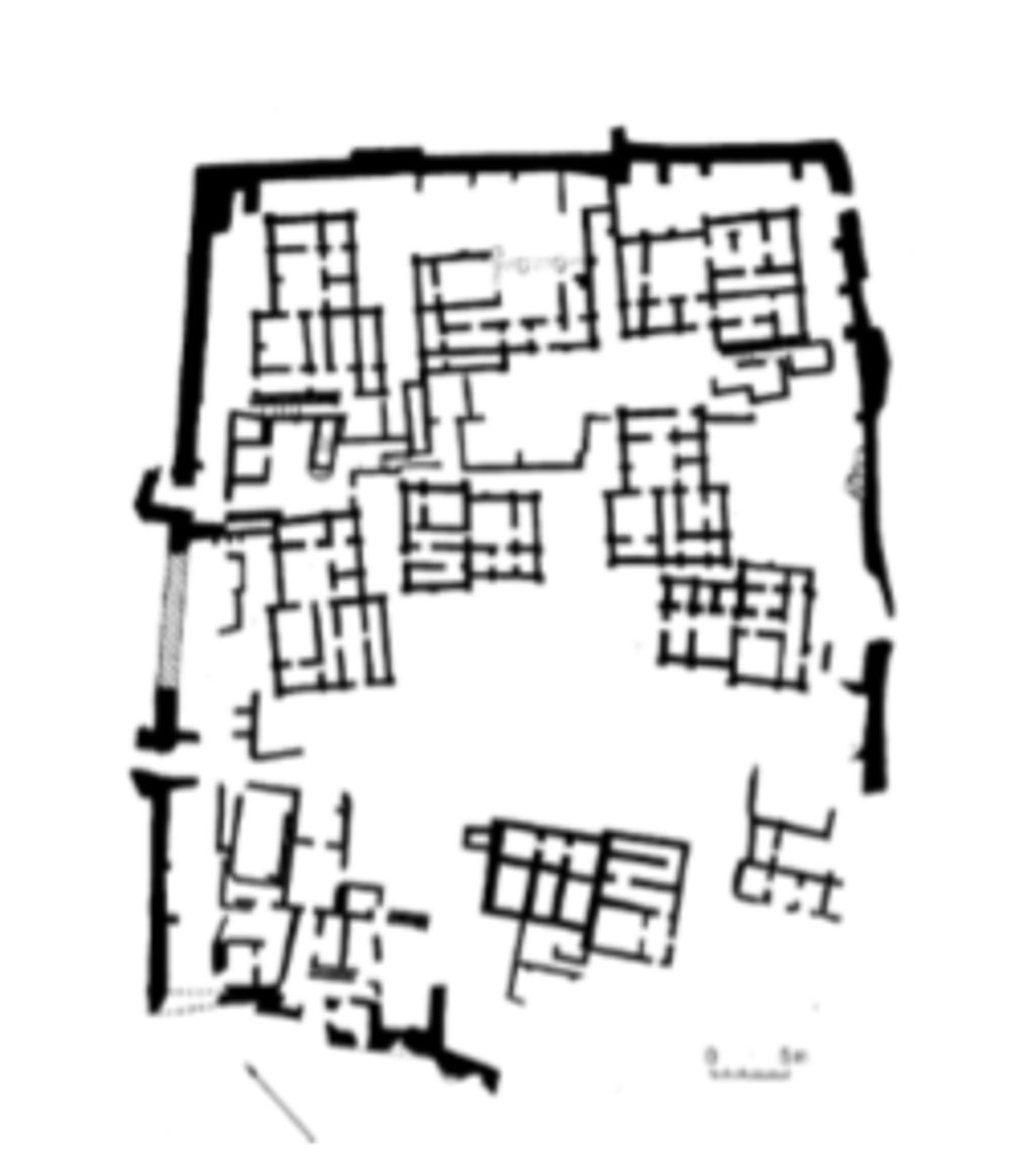 <p>a large T-shaped building with fourteen rooms overlying a cemetery</p>