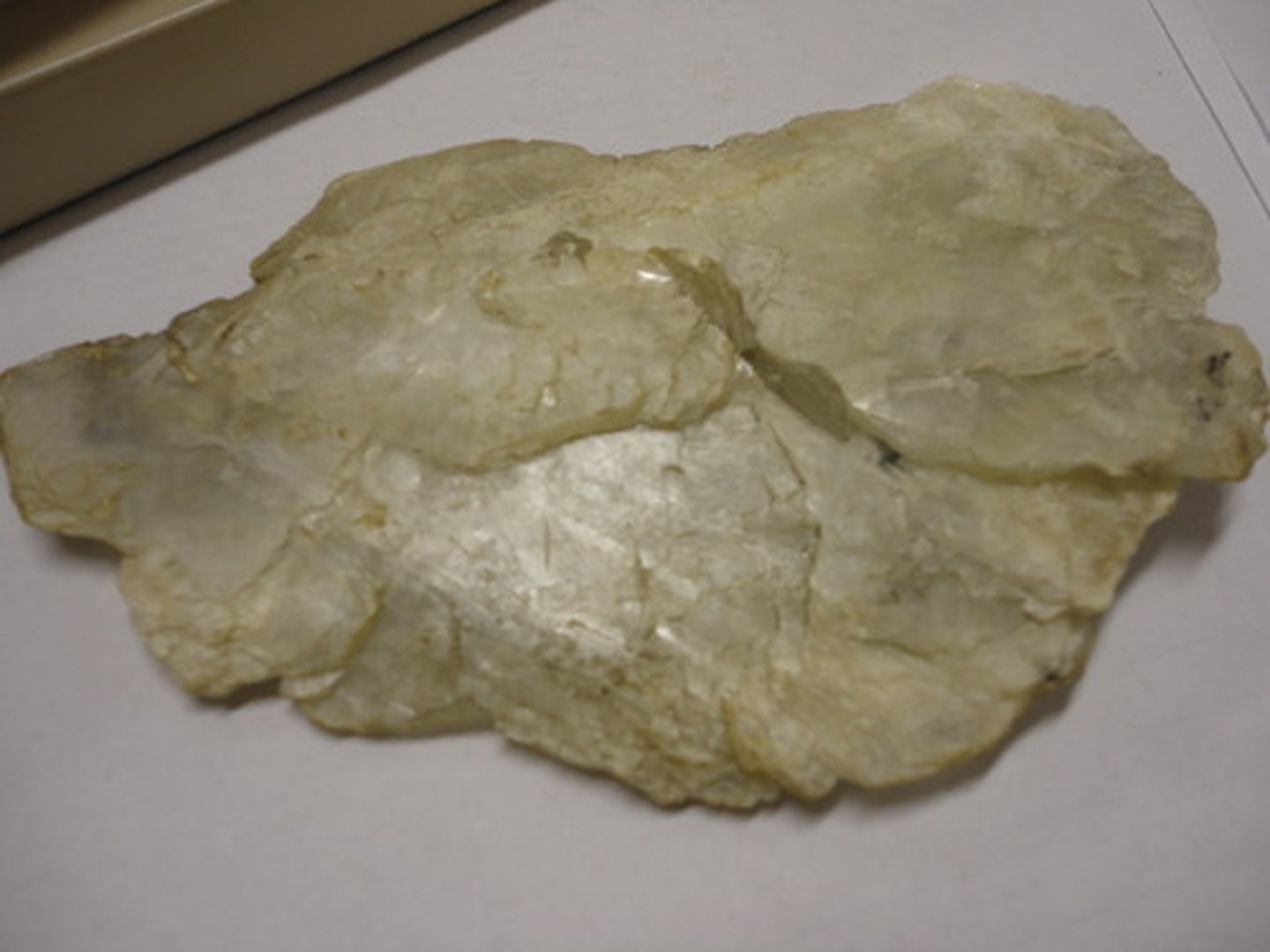 <p>Hexagonal.<br>Commonly foliated, massive.<br>H = 2.5<br>SG = 2.39<br>Transparent to translucent.<br>Pearly (base) and vitreous to waxy (elsewhere) luster.<br>Color = white, gray, light green.<br>Associated with serpentine, dolomite, magnesite, and chromite as an alteration product of Mg-silicates.</p>