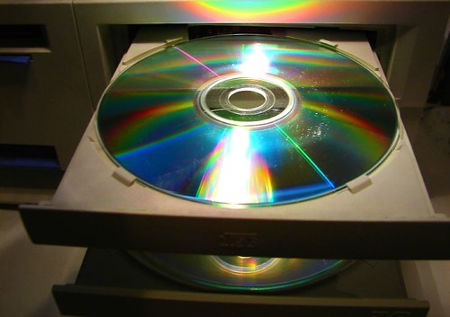 <p>Optical storage media, including CDs DVDs and Blu-Ray disks, are written to and read from using lasers.<br>Just like magnetic disks, optical disks spin to allow the laser to read the data from the correct location.<br><br>The surface of the disk will have billions of locations in which pits can be physically burned by a laser, or not burned, to represent either a `0` or a `1`</p>
