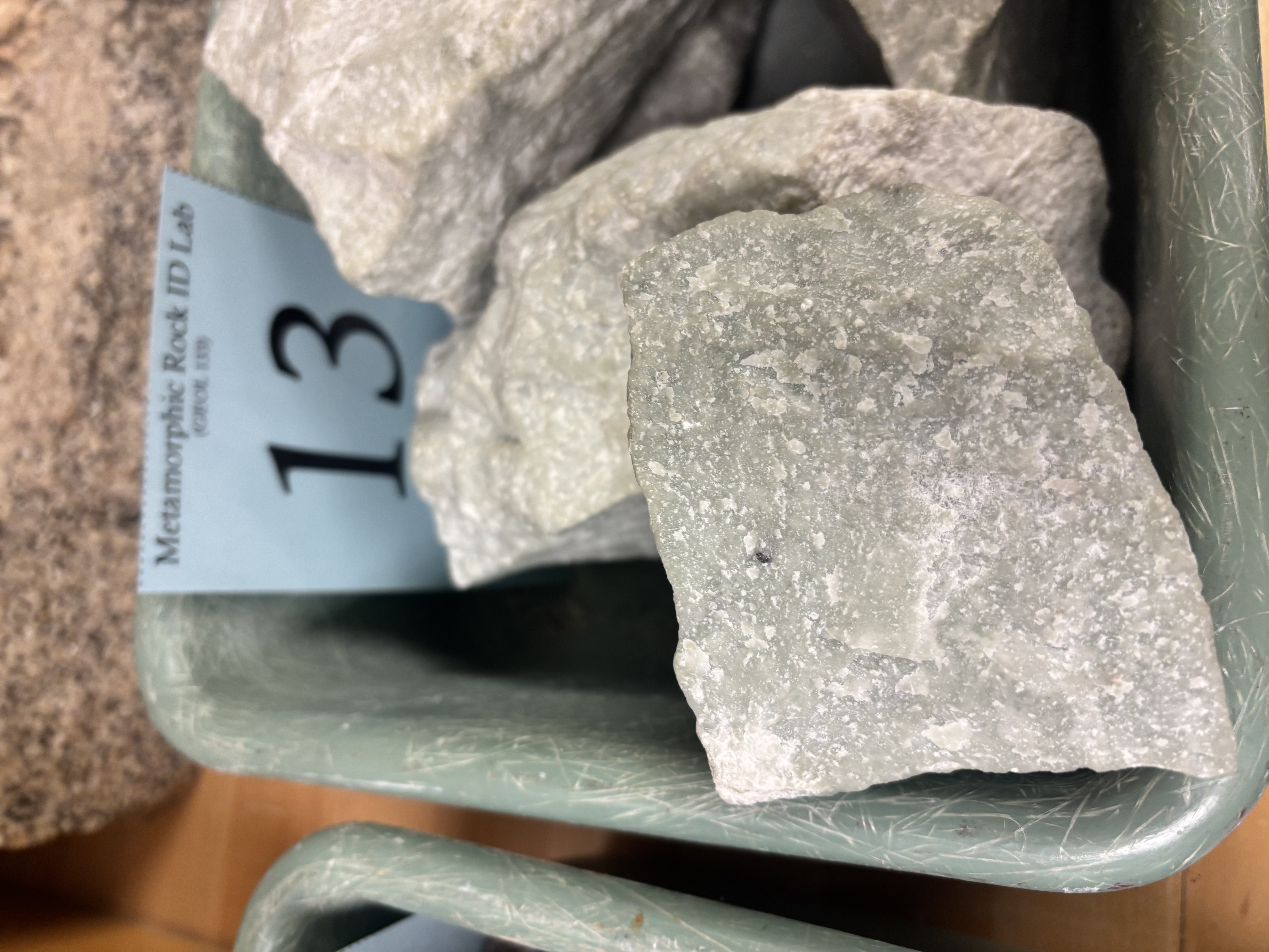 <p>Non-foliated metamorphic rock formed from limestone or dolostone; composed of calcite; reacts with acid.</p>