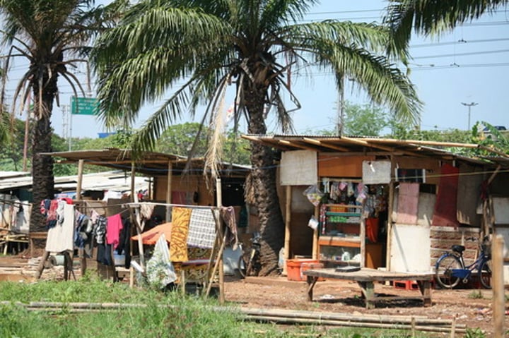 <p>An area within a city in a less developed country in which people illegally establish residences on land they do not own or rent and erect homemade structures.</p>