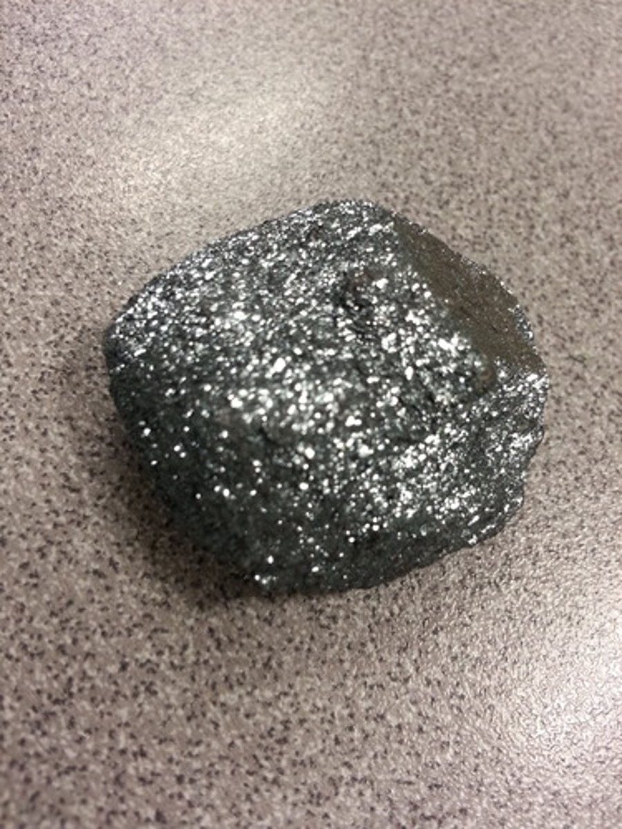 <p>In respect to iron ores: mirror like (Specular Hematite)</p>