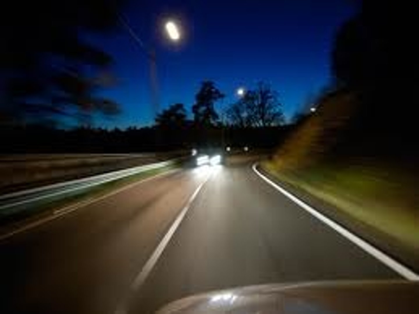 <p>500 feet of an upcoming vehicle, and 300 feet behind a vehicle</p>