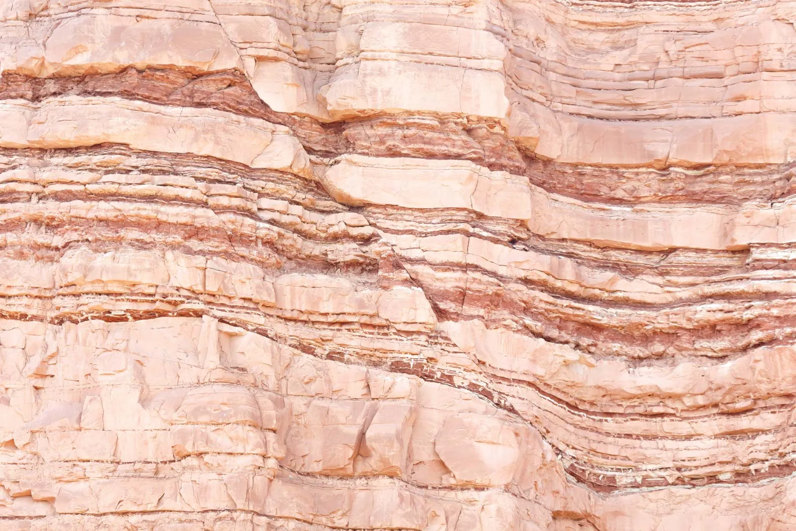 The fracturing of rock with movement from its original position