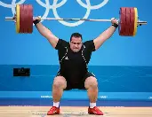 <p>exercising by <strong>lifting heavy weights to build strength</strong>.</p>