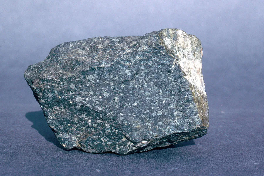 <p>Igneous rock: Andesite</p><p><strong>Andesite is an extrusive igneous rock composed primarily of plagioclase feldspar and large amounts of mafic minerals like hornblende. It has an aphanitic texture, meaning its interlocking crystals cannot be seen by the naked eye. Andesite comes in many colors but is usually light or dark gray, and is often porphyritic.</strong></p><p><strong>Andesite has a fine-grained texture with very small, interlocking crystals of white to off-white plagioclase feldspar and darker, mafic minerals like hornblende. The crystals are too small to see with the naked eye. Andesite is usually light to dark gray and often contains larger crystals called phenocrysts.</strong></p>