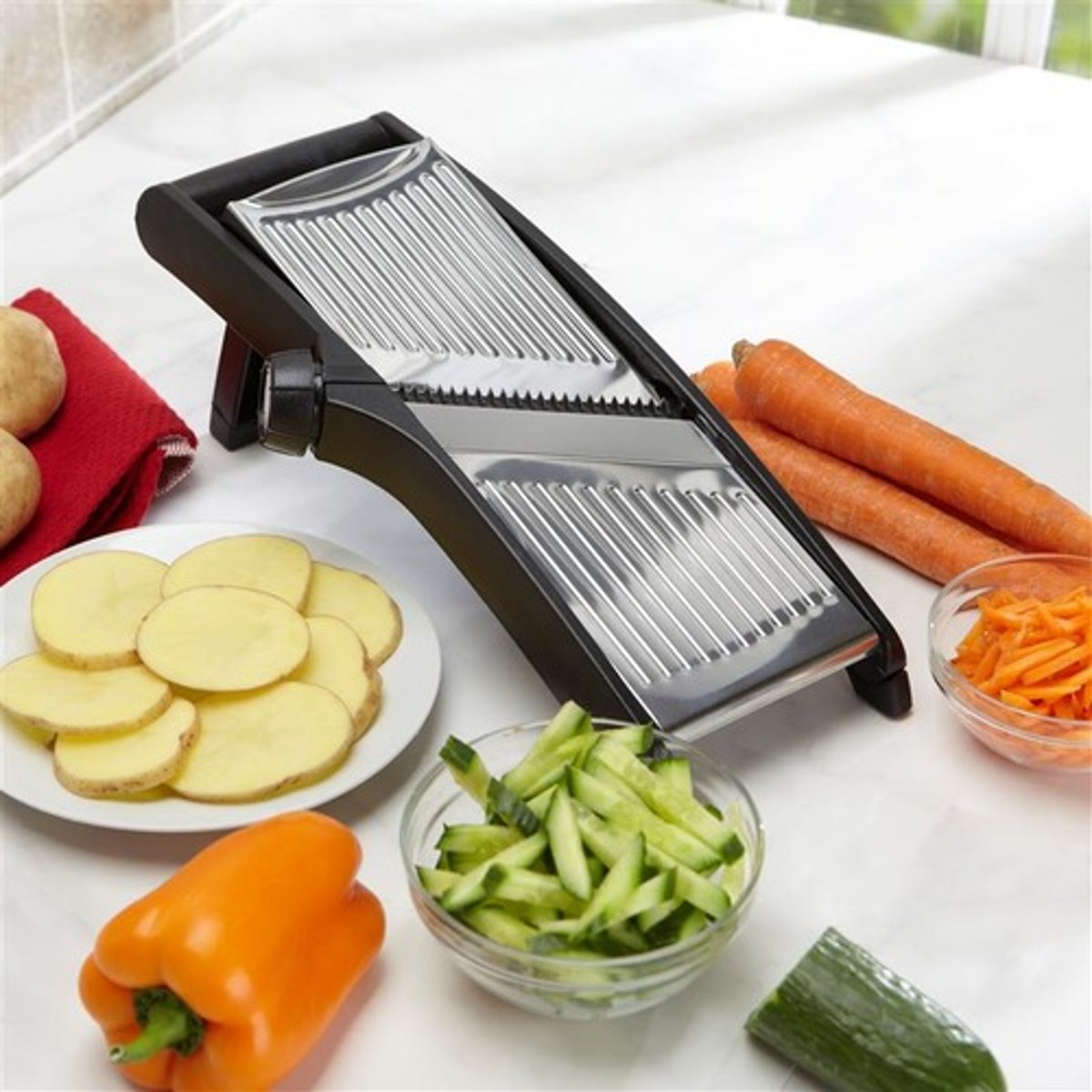 <p>A manually operated slicer made of stainless steel with adjustable slicing blades to slice and julienne. Its narrow, rectangular body sits on the work counter at a 45-degree angle. It is useful for slicing small quantities of fruit or vegetables, situations where a large electric slicer isn't necessary.</p>