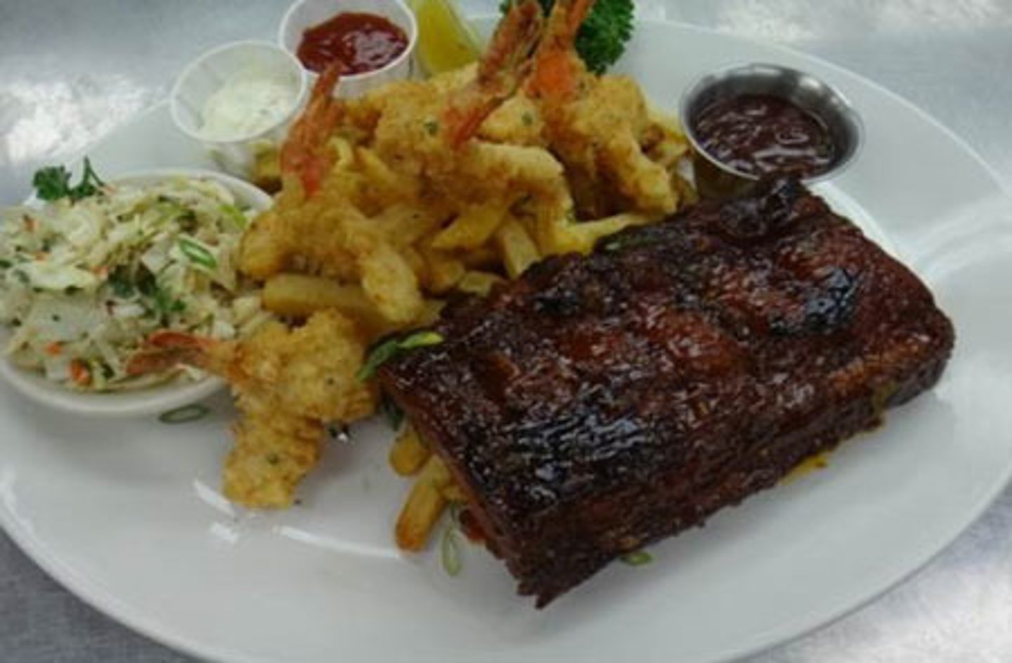 <p>a 4 bones portion of our "fall-off-the-bone" ribs with seasoned steak fries.<br>wet nap</p>