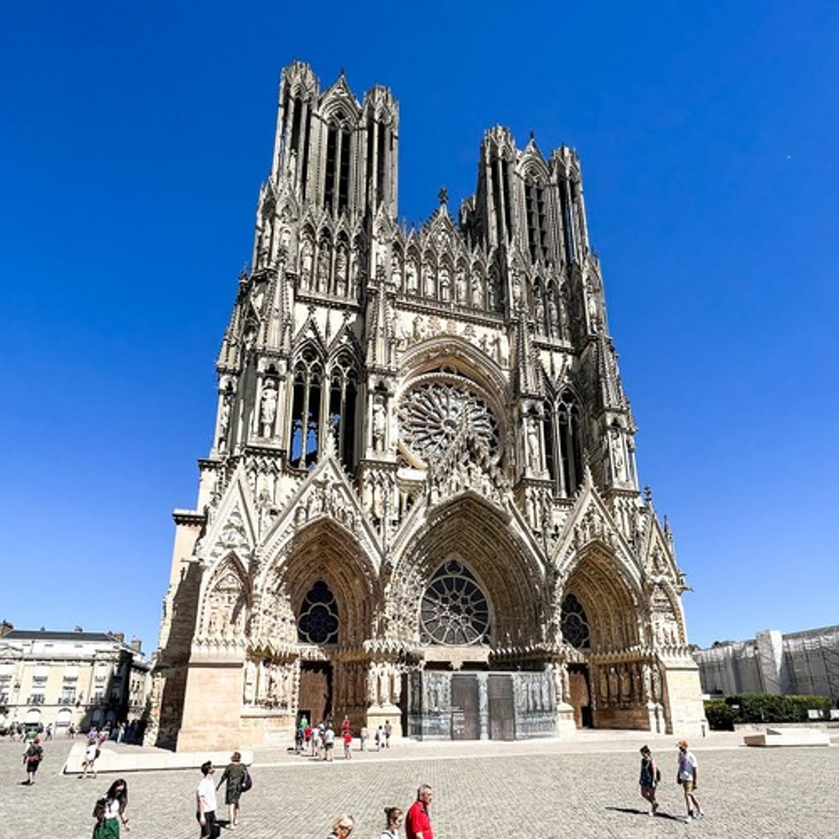 <ul><li><p><span style="background-color: transparent;"><span>A church existed at Reims first, where Clovis, the first king of the Franks, was baptized</span></span></p></li><li><p><span style="background-color: transparent;"><span>After a fire destroyed the earlier Romanesque church, Archbishop Aubry de Humbert initiated the new Gothic cathedral</span></span></p></li><li><p><span style="background-color: transparent;"><span>Reims became the traditional site of French royal coronations</span></span></p></li><li><p><span style="background-color: transparent;"><span>Cross plan with a long nave, wide transept, and deep choir</span></span></p></li><li><p><span style="background-color: transparent;"><span>Vaults emphasize verticality and light</span></span></p></li><li><p><span style="background-color: transparent;"><span>Use of flying buttresses to support tall walls and large stained glass windows</span></span></p></li><li><p><span style="background-color: transparent;"><span>Over 2,300 statues, making it one of most sculpturally rich cathedrals in Europe</span></span></p></li><li><p><span style="background-color: transparent;"><span>Portals depict biblical narratives, saints, and coronation imagery</span></span></p></li></ul><p></p>