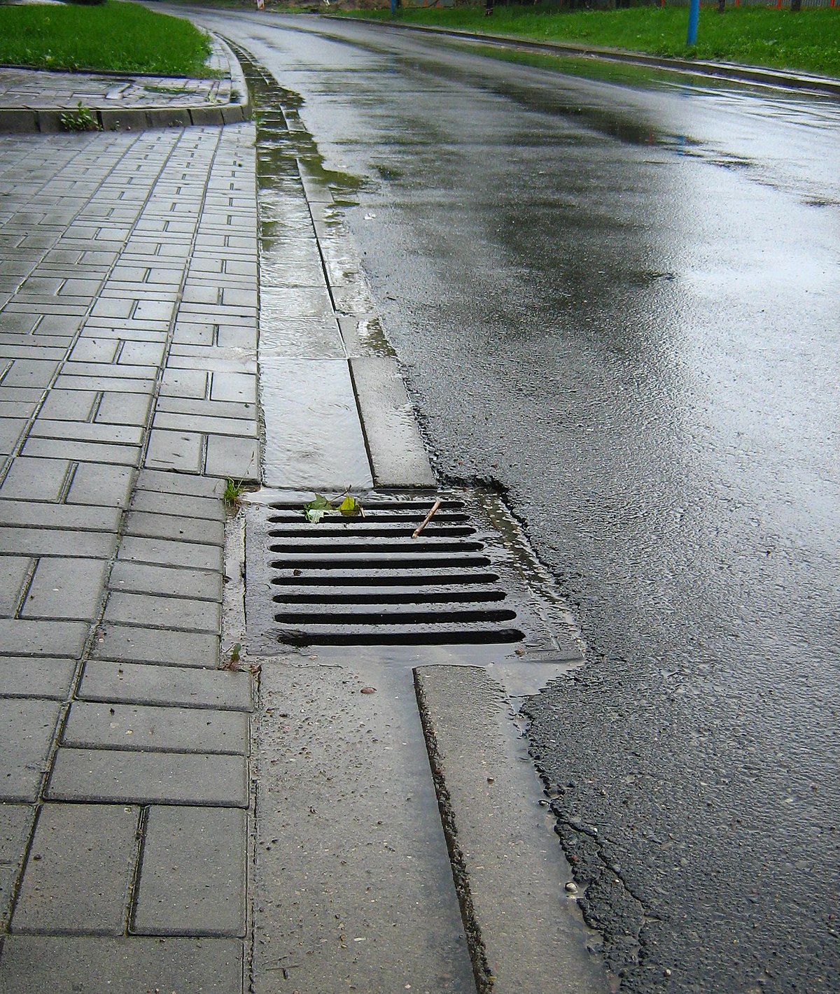 <p>drain that carries water away from a parking lot or street</p>