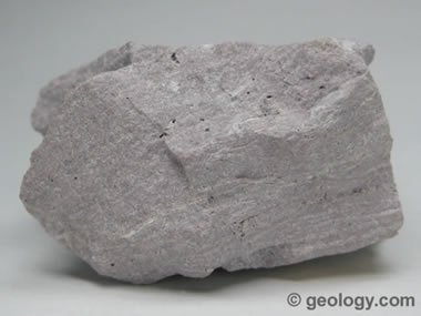 <p>What is the texture does Rhyolite have and what type of cooling caused it?</p>
