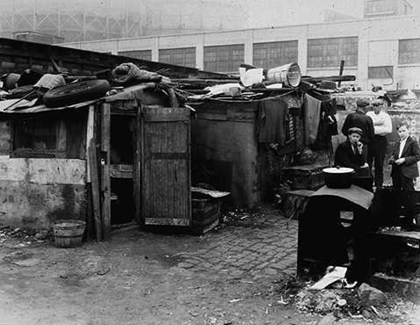<p>Unplanned slum development on the margins of cities, dominated by crude dwellings and shelters made mostly of scrap wood, iron, and even pieces of cardboard.</p>