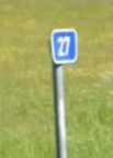 <p>Kilometer marker parallel to the road</p>