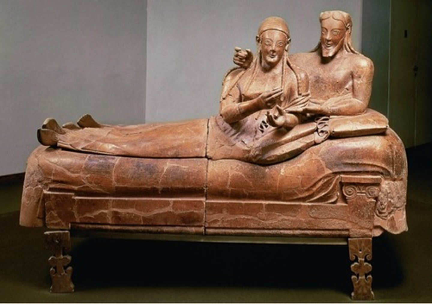 <p>Form:<br>-terra cotta (sign that this is Etruscan)<br>-lifesize<br>-archaic smile, patterned hair<br>-extending arms<br>Content:<br>-husband and wife reclining on a couch dining "dining in banquet for eternity"<br>-four pieces put together<br>Function:<br>-funerary container to hold ashes not the body<br>Context:<br>-520 BCE Etruscan</p>