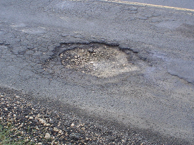 <p>the pavement surface resulting from the loss of wearing course</p>