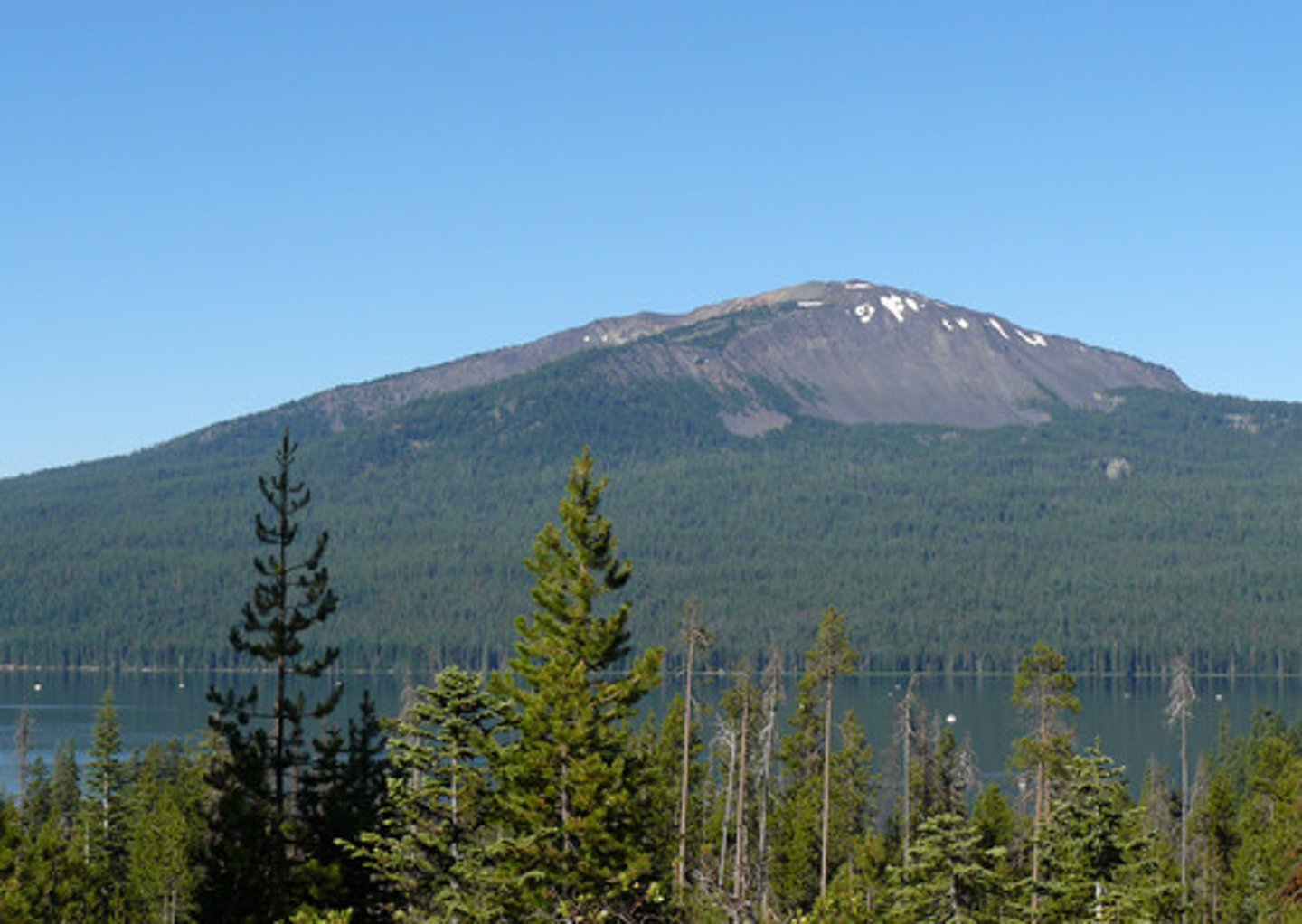<p>Found at constructive plate margins or at hotspots and has gentle sloping sides. It has runny, non-acidic lava, and less violent eruptions.</p>