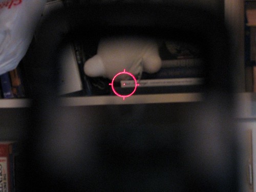 <p>This sighting device uses a non-magnifying gunsight that allows the user to look through a glass optical window and see a holographic reticle image superimposed at a distance on the field of view.</p>
