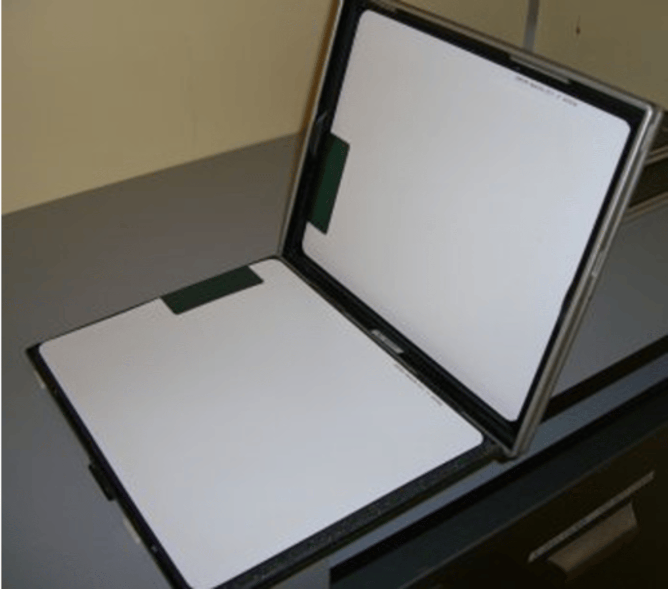 <p>- Holds the film and protects it from physical damage and light exposure</p><p>- Holds the screens and protects them from physical damage</p>