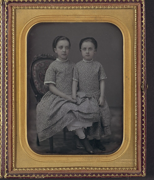 <p>Two Girls in Identical Dresses</p>
