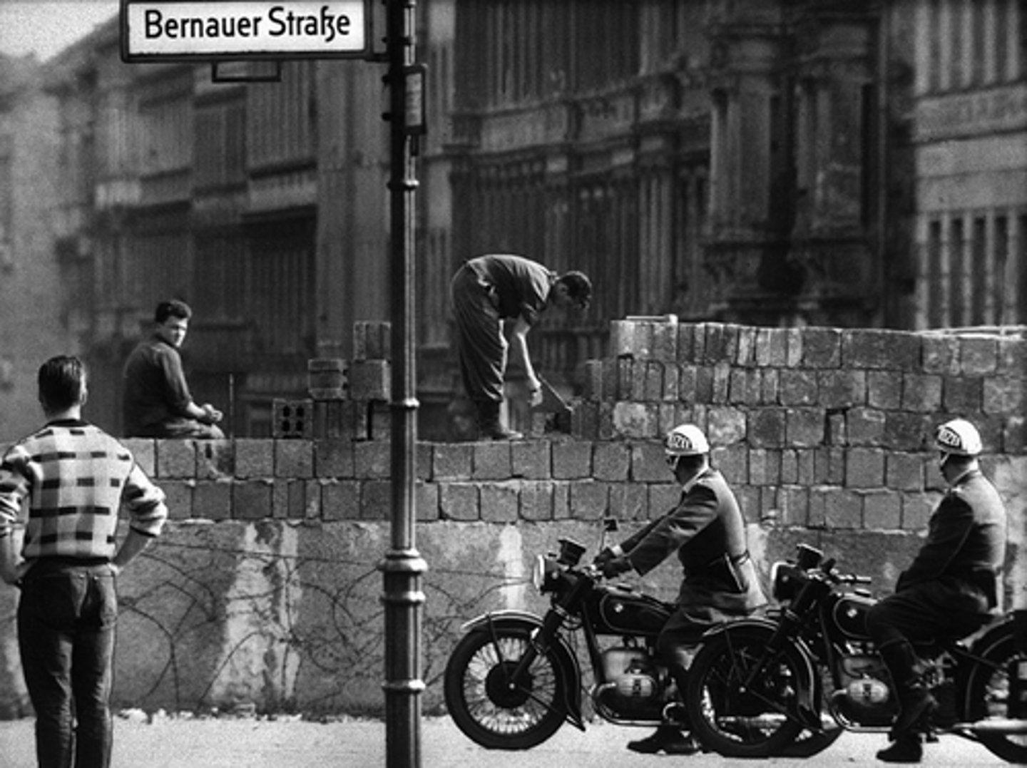 <p>A concrete wall that separated East Berlin and West Berlin from 1961-1989, built by Communist East German government to prevent its citizens from fleeing to the West.</p>