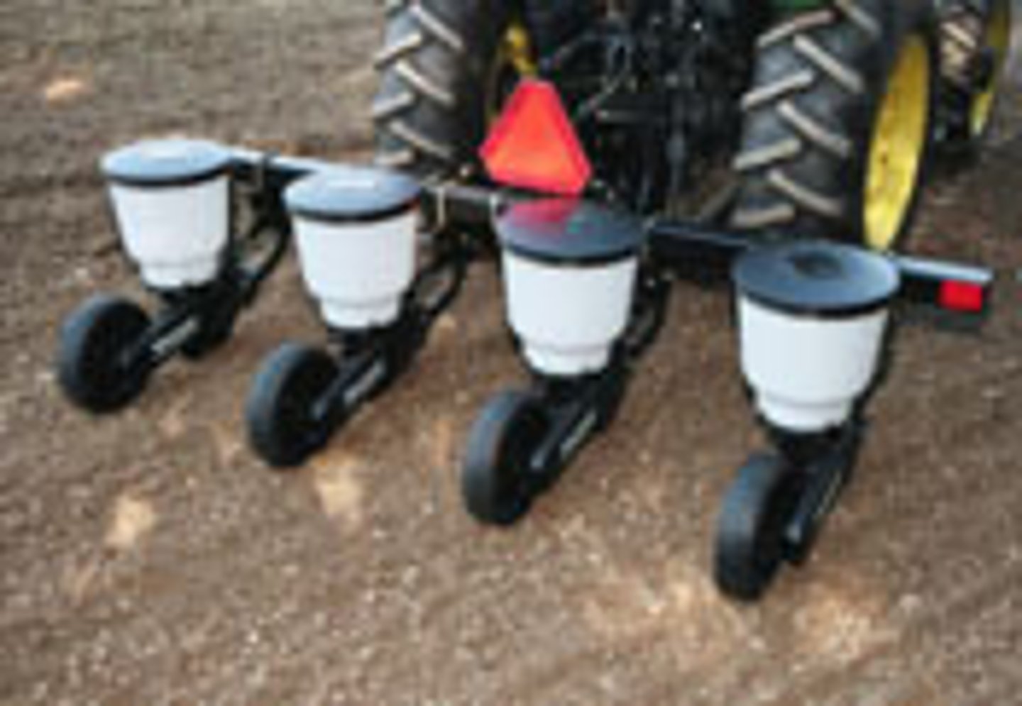 <p>a farm implement, usually towed behind a tractor, that sows seeds in rows throughout a field</p>