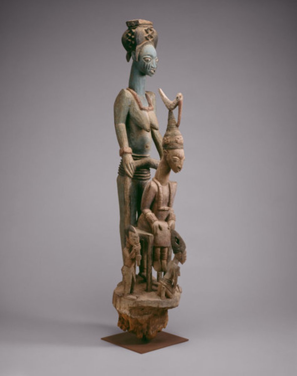 <p>YORUBA PEOPLE, wood and pigment.<br><br>Four veranda posts carved for a palace. <br>Liberal use of negative space, openness!!!!<br><br>KING AT THE CENTER! Senior wife crowns the king, protects and advises him. LARGE! IMPORTANT<br>Large heads (smarties) and large eyes<br>Flute playing god, junior wife, fan bearer</p>