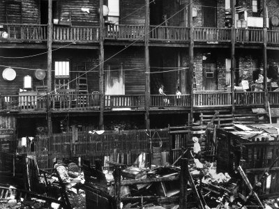 multifamily urban houses that were often overcrowded and unsanitary