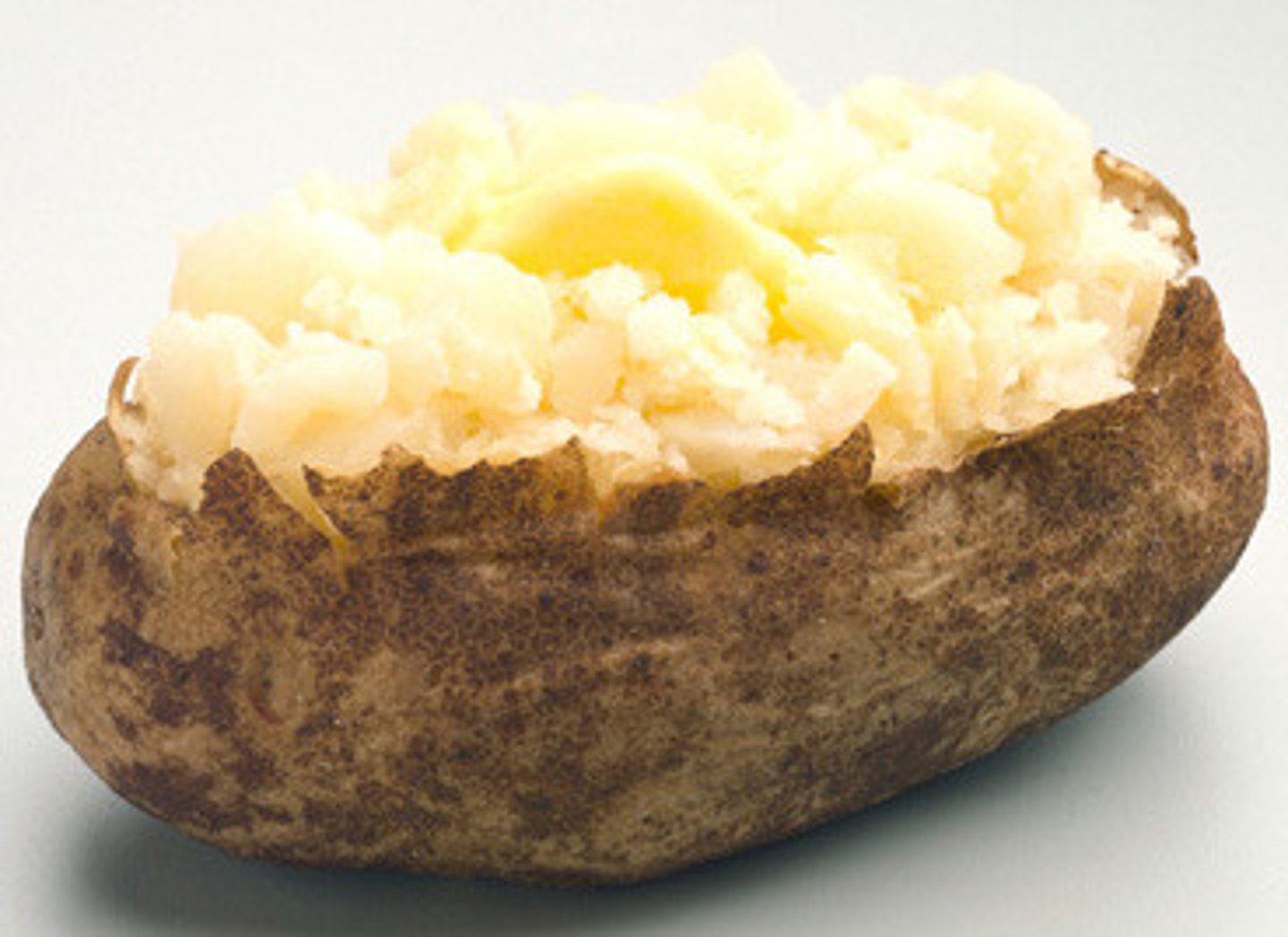 <p>Large baked potato coated with baking grease and kosher salt<br>Loaded: butter sour cream cheese bacon<br>Chili and cheese</p>