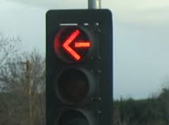 If you intend to move in the direction indicated by the arrow, come to a complete stop before reaching the stop line, crosswalk, or intersection. Remain stopped as long as the arrow signal is red.