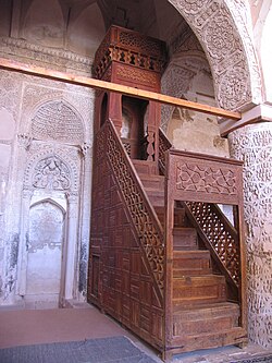 <p><span>A raised platform or pulpit located to the right of the Mihrab, where the Imam stands to deliver the sermon (Khutbah). It usually has steps leading up to it.</span></p>