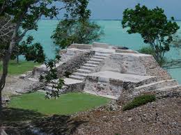 <p>Late Formative. Pyramid-esque, right by the sea. Along staircase are large masks of jaguar sun (to the right). Would have been a temple on top. The designs on either side are chronological figures referring to celestial activity</p>