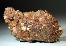 <p>-sedimentary</p><p>-clastic</p><p>-coarse grained</p><p>-poorly sorted</p><p>-rounded to subrounded</p><p>-quartz, chert</p><p>-sediments deposited by fast-moving rivers and streams, or by wave action along beaches, where these clasts are transported and then cemented together over time</p><p>uses: construction</p>