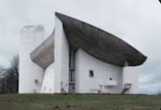 <p><span><span>Sculptural curved walls, thick roof, small windows</span></span></p>