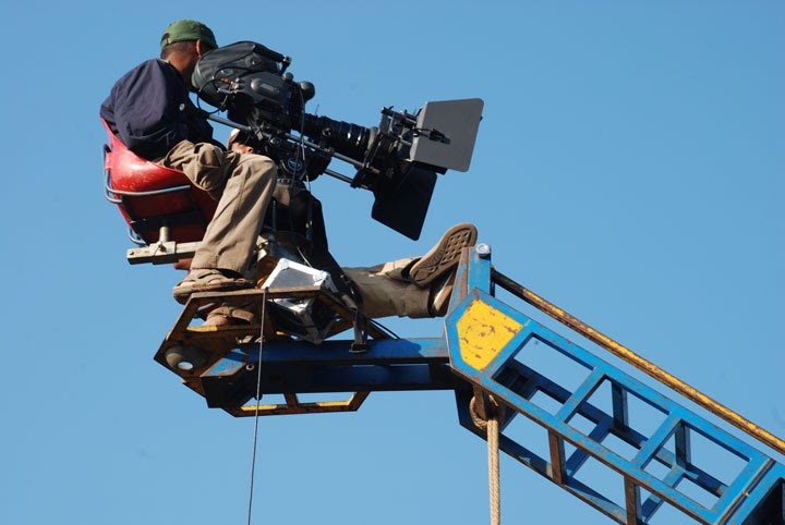 <p><strong>CRANE SHOT</strong></p><p>Camera being mounted on a crane or jib. It uses a wide, high perspective to be achieved. </p>