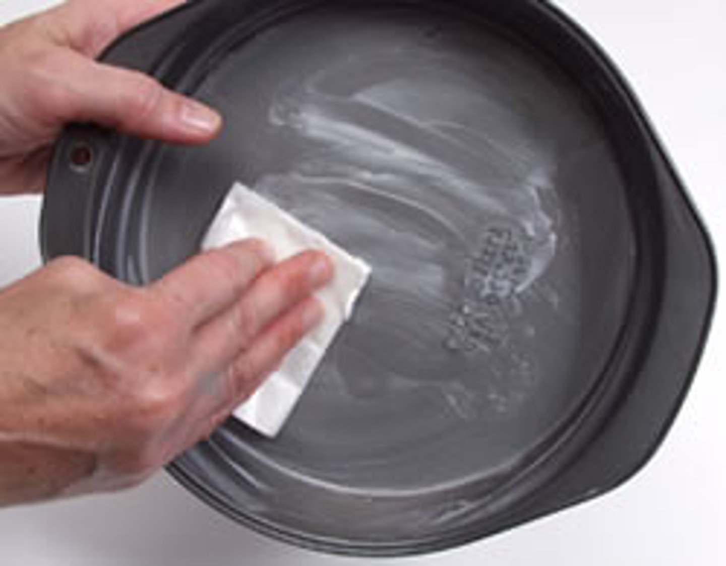 <p>To rub fat on the surface of a cooking utensil or on a food itself.</p>