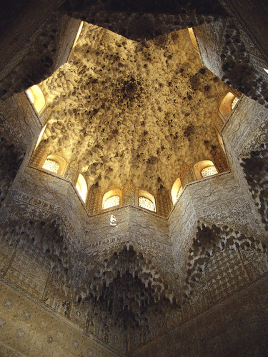 <p>"Stucco decorations of Islamic buildings in which stalactite-like forms break a structure's solidity."</p>