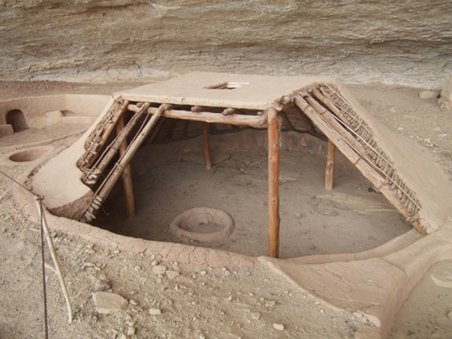 <p>houses dug into the ground and covered with wood and skins</p>