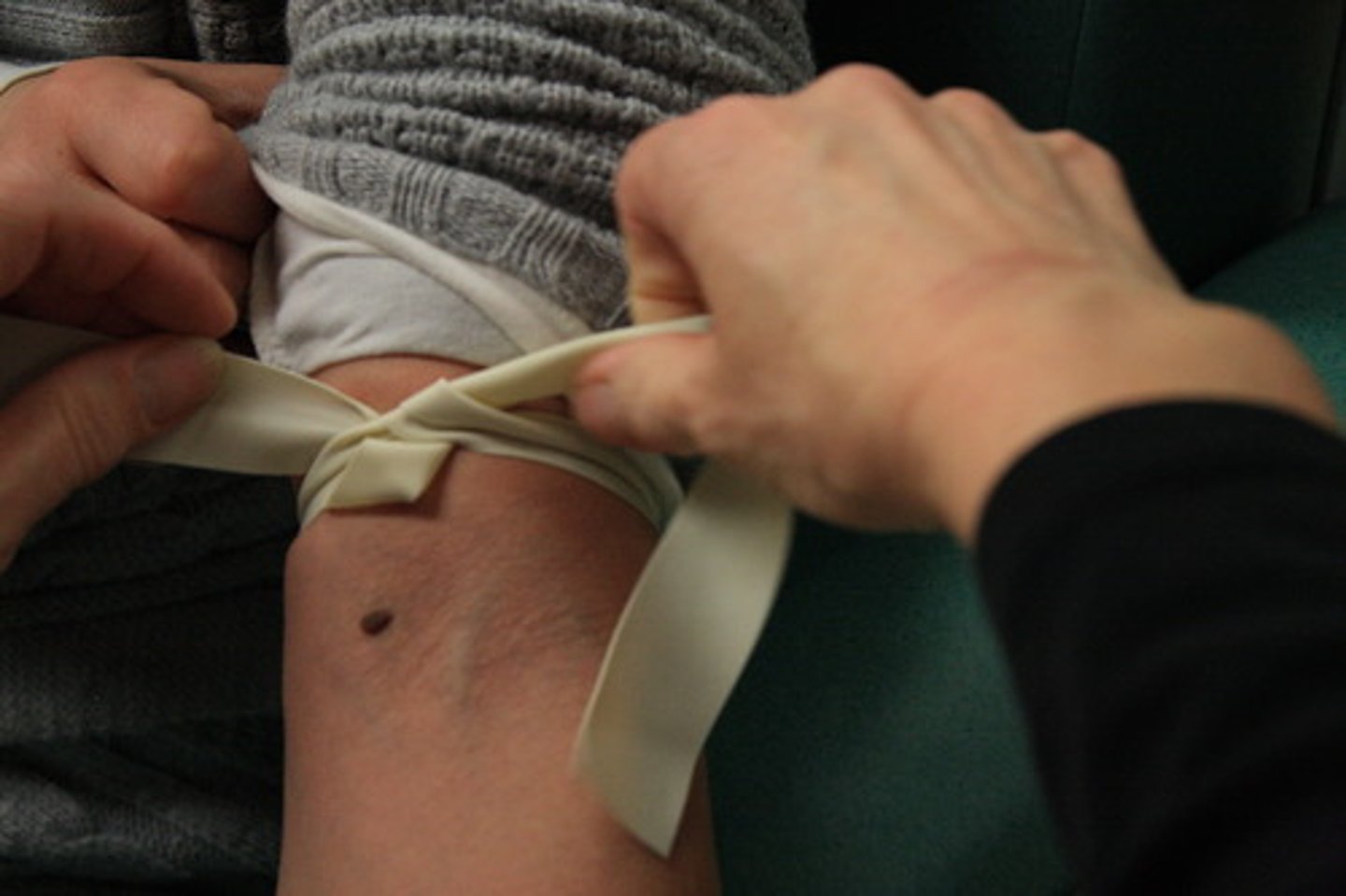 <p>a bandage or other material wrapped tightly around a bleeding limb to stop the flow of blood</p>