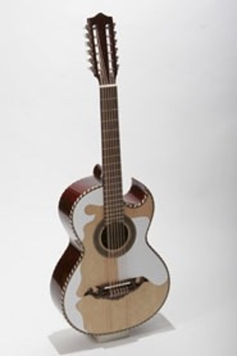 <p>Oversized Mexican twelve-string guitar that typically served as a bass instrument in small groups.</p>