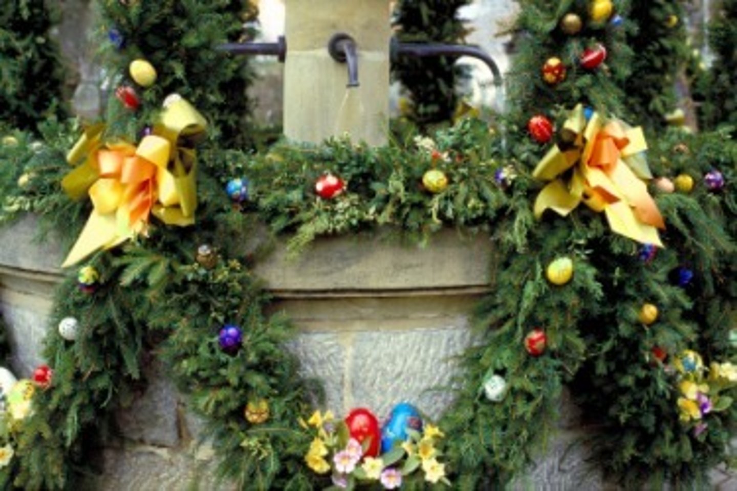 <p>a wreath made of plants and other materials hung in a loop</p>