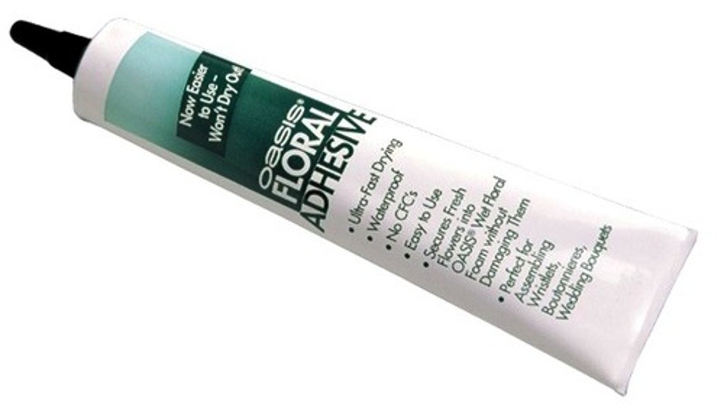 <p>quick drying, waterproof adhesive which will not brown leaves; available in liquid,</p><p>spray and tape forms</p>