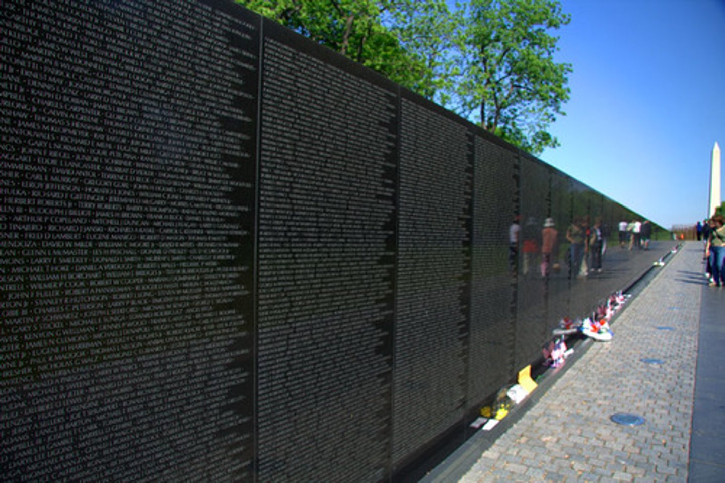 <p>Washington, D.C., U.S.</p><p>Maya Lin</p><p>1982 CE</p><p>Form: Granite</p><p>Function: Serve as a monument for those soldiers who lost their lives during the war.</p><p>The Vietnam Veterans memorial is a black, V-shaped granite structure that is built down into the earth. Along the walls are the carved names of the over 57,000 soldiers who died as a result of the war. The monument allows the visitor to descend down a sloped walkway to the corner of the V and then ascend again along the other half as it moves closer to ground level. The highly reflective granite surface allows the viewer to see a reflection of themselves in the walls. Visitors can also use slips of paper and pencils to create etchings of their loved ones' names. Maya Lin was the designer of the selected plans and began construction on a monument that was unlike most traditional ones. Some critics found it to be too dark and abstract. There were even displays of modern racism in the fact that some criticized the selection of Maya Lin simply because she was a Chinese-American woman.</p>