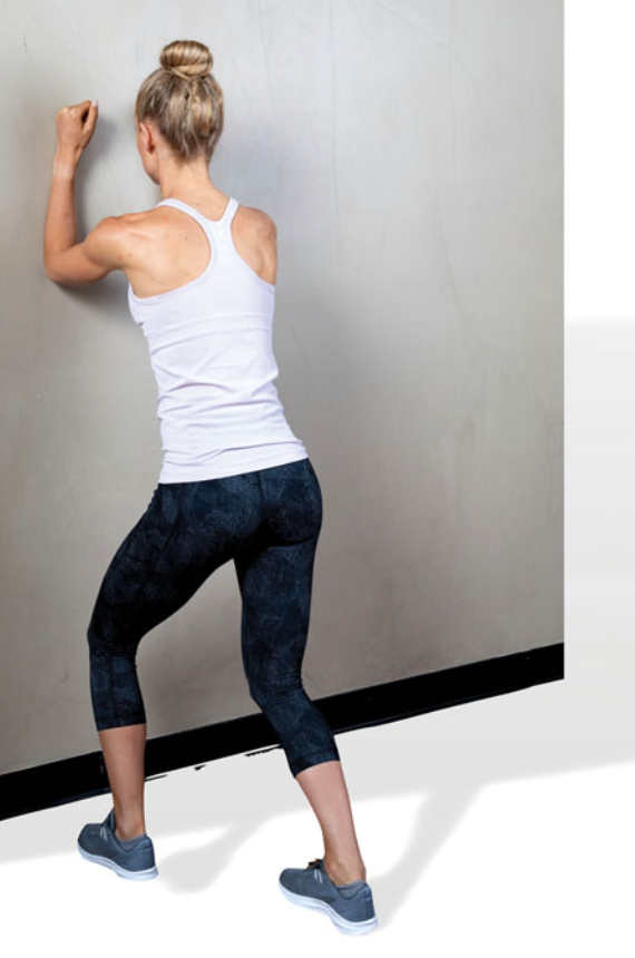 stand in a lunge position with both feet pointing straight forward and back knee slightly flexed

make sure to keep the rear foot flat on the ground

do not let the heel rise up

shift weight forward until a stretch is felt in the rear calf muscle