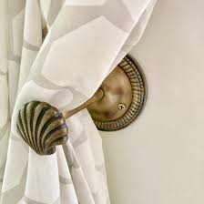 <ul><li><p>are simple or ornamental knob or hooks where you attach the tie backs </p></li></ul><p></p>