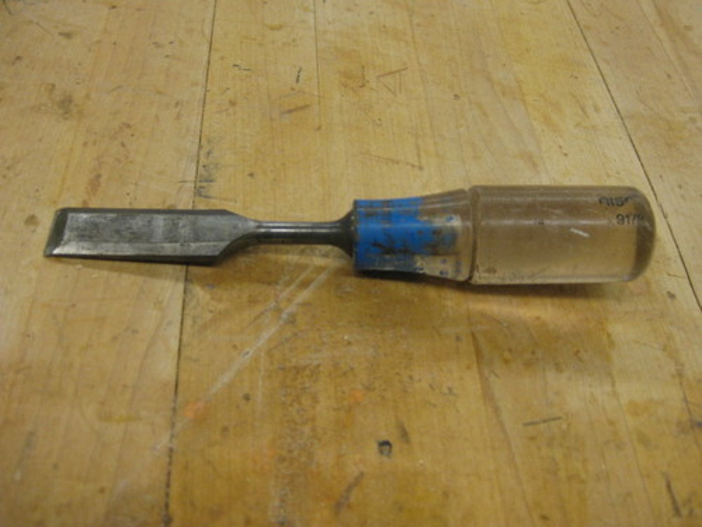 <p>a piece of steel that is pointed at one end and flat on the other end.</p>