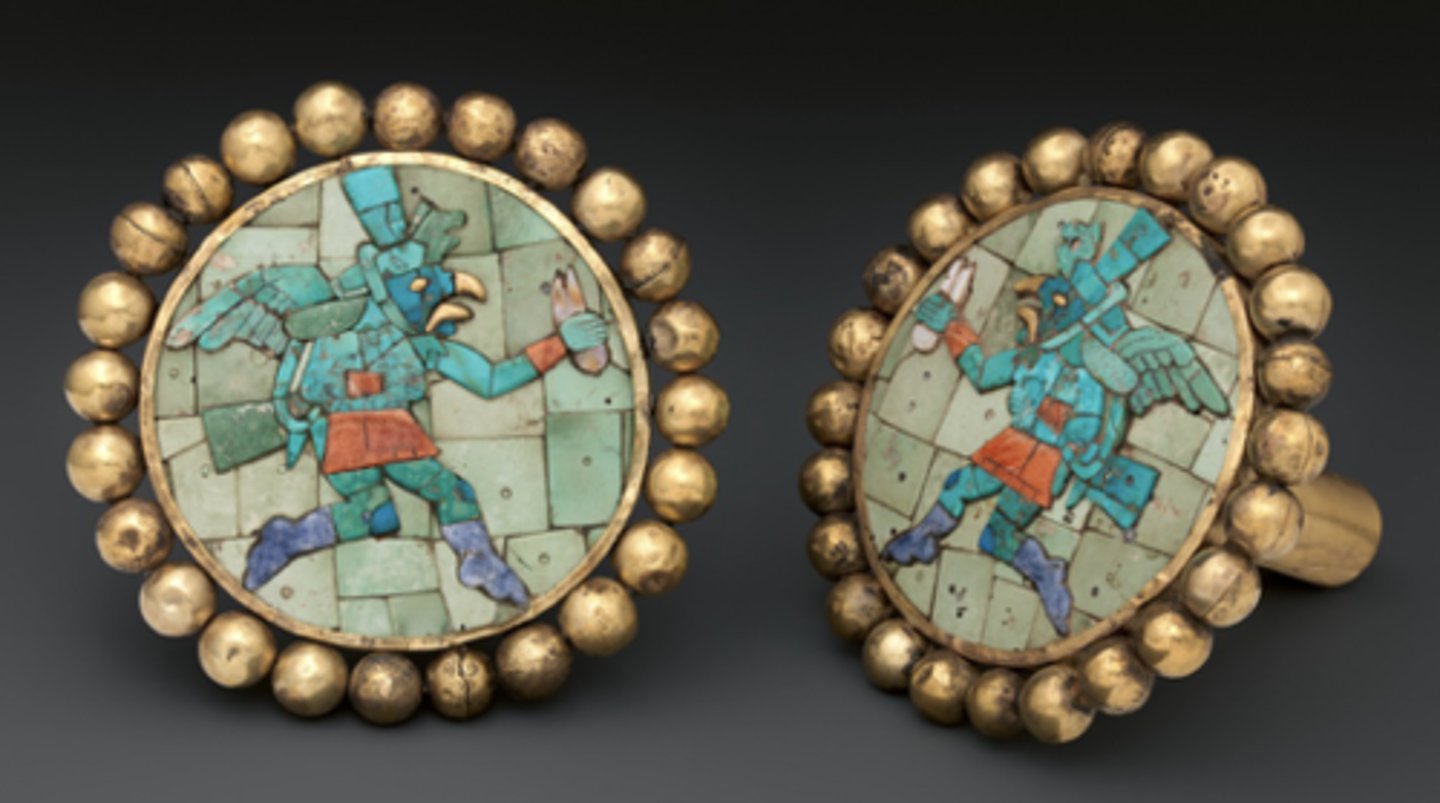 <p>Large, decorative ear ornaments made of jade or other precious materials, worn by elites.</p>