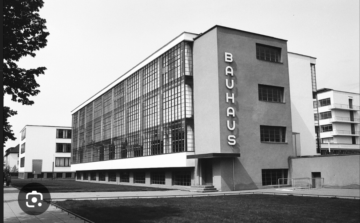 <p><span><span>White boxes, flat roofs, ribbon windows, pinwheel housing layout</span></span></p>