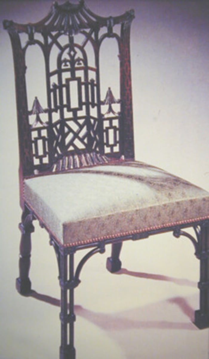 <p>Chair designed by Thomas Chippendale featuring fretwork panels in the arms and the back of the chair.</p>